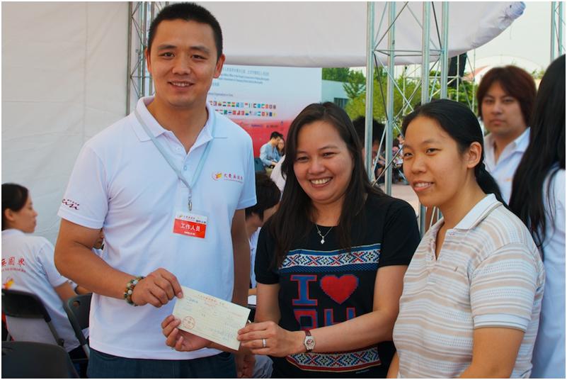 First Secretary and Consul Rhenita Rodriguez and Third Secretary and Vice Consul Lily Ann Cheng turn over the donations from the Philippine Embassy to the event organizers. bazaar4-2012